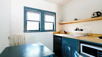 Fridge, microwave, coffee/tea maker, cookware/dishes/utensils