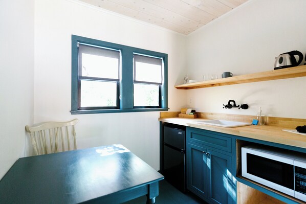 Fridge, microwave, coffee/tea maker, cookware/dishes/utensils