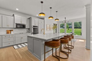 Dishwasher, coffee/tea maker, cookware/dishes/utensils, dining tables