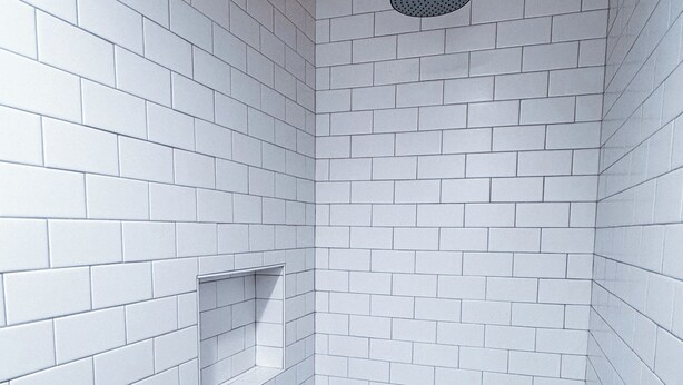A bathroom with white tiled walls and a wooden ceiling. - Amber Cottage at Piety Hill Cottages (NEVADA CITY)