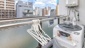 A balcony with a view of a cityscape, a water body, and a utility meter. - 5-minute walk from Nihonbashi Station/ Luggage storage available in front of the building/ Families are welcome/ Within walking distance of Kuromon Market, Shinsaibashi, and Namba/ 24-hour supermarket nearby/ Fixed Wi-Fi available (Osaka City)