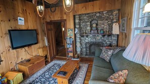 Signature House, Multiple Beds, Patio, Lake View | Living room | 50-inch Smart TV with digital channels, fireplace, books - Valhalla (Sunapee)