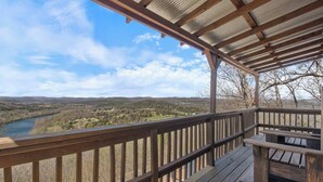 A wooden deck with a view of a river and hills. - Cabin w/King Bed, Jacuzzi + View (Carroll County)