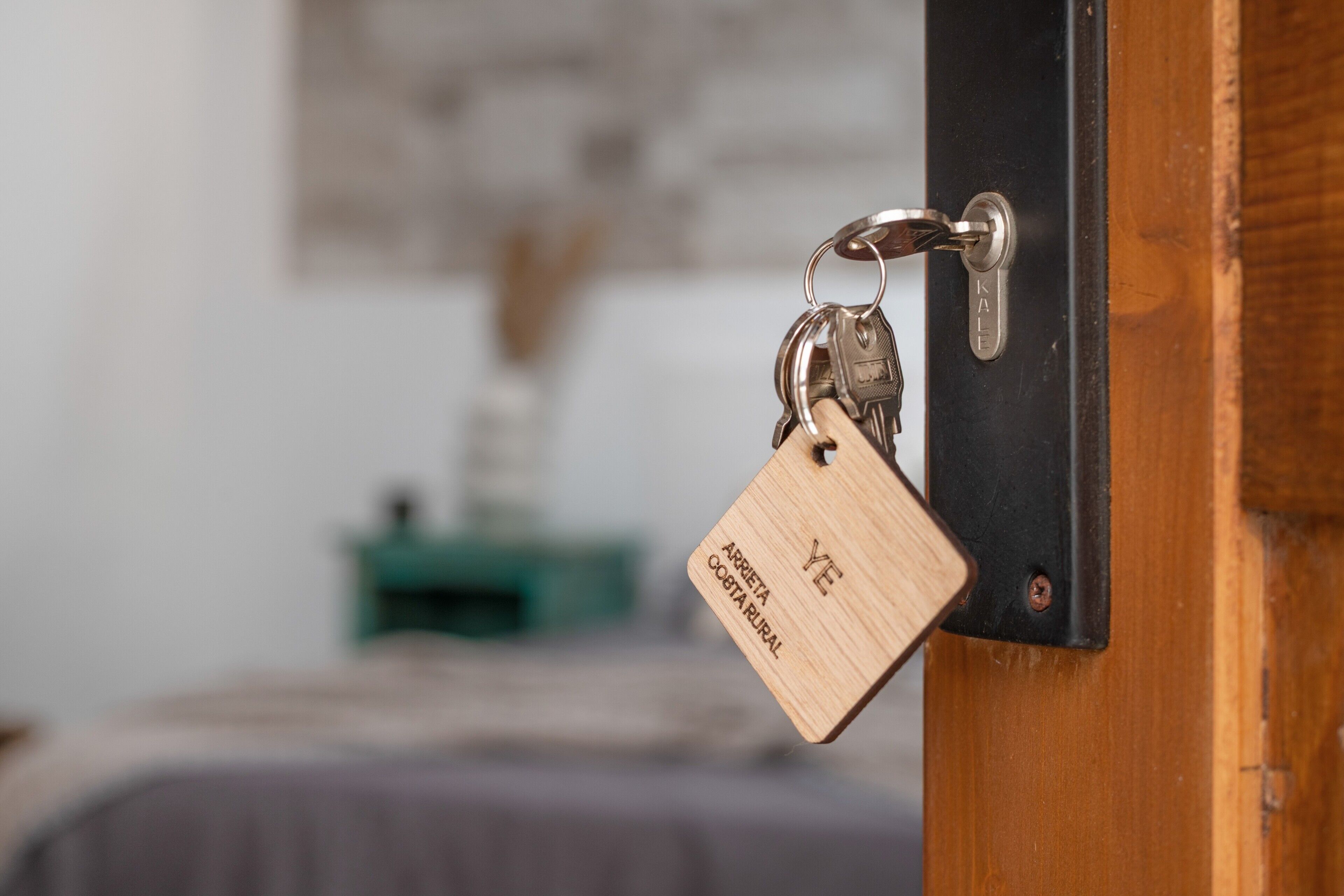 A door with a keychain and a wooden tag.