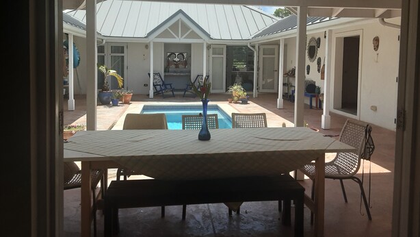A covered outdoor area with a pool, seating, and a view of the sky. -  A Hidden Bed & breakfast with live-in host  Private, Peaceful with Plunge pool. (Christ Church)