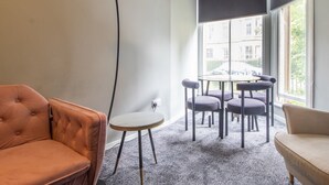 A modern living room with a sofa, a small round table, and a dining set. - Pass the Keys | Cosy in Fabulous West End (Glasgow)