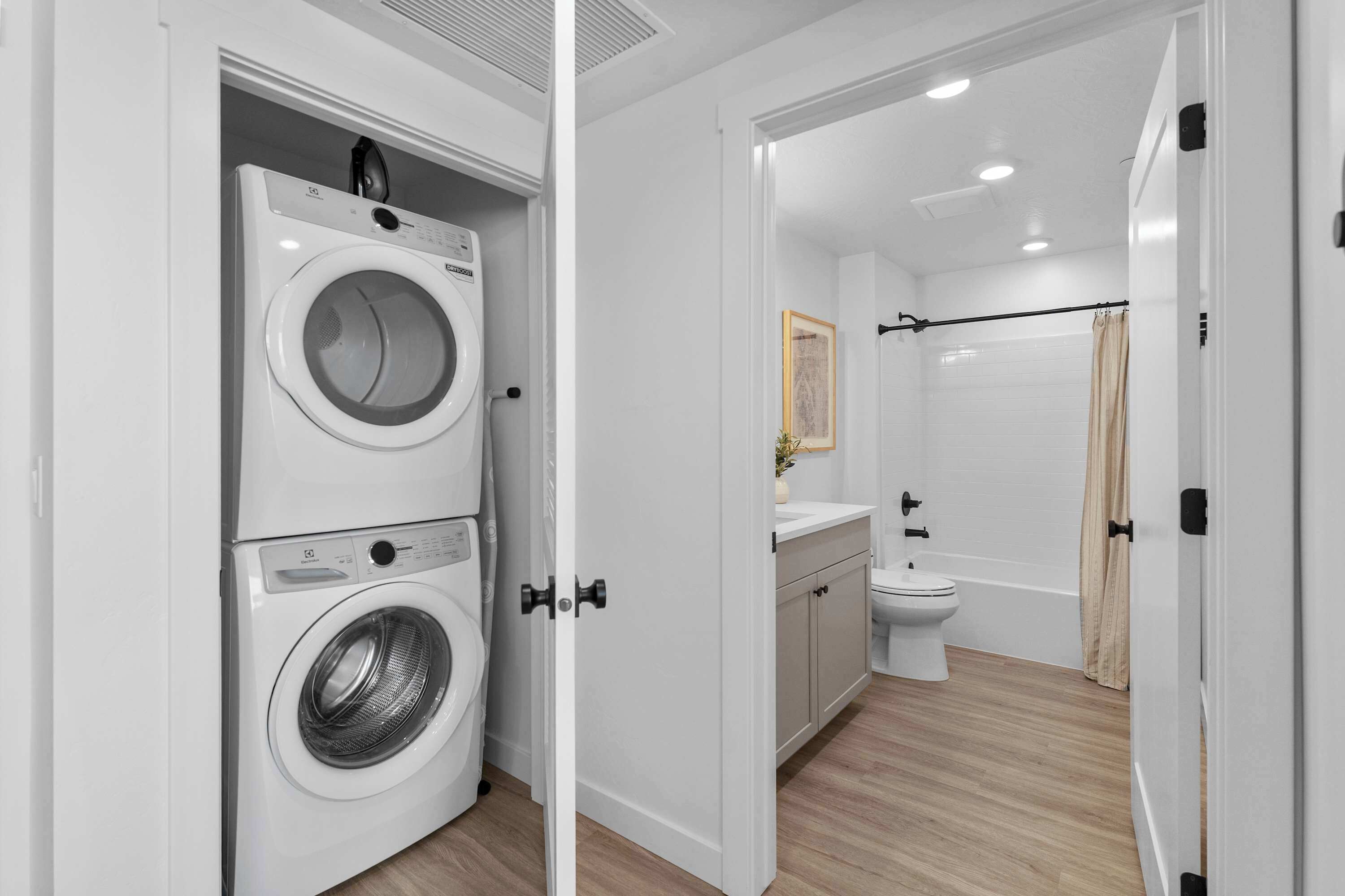 A modern bathroom with a toilet, sink, and shower.