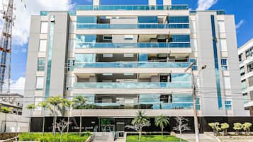 A multi-story hotel with a modern design, featuring balconies and large windows.