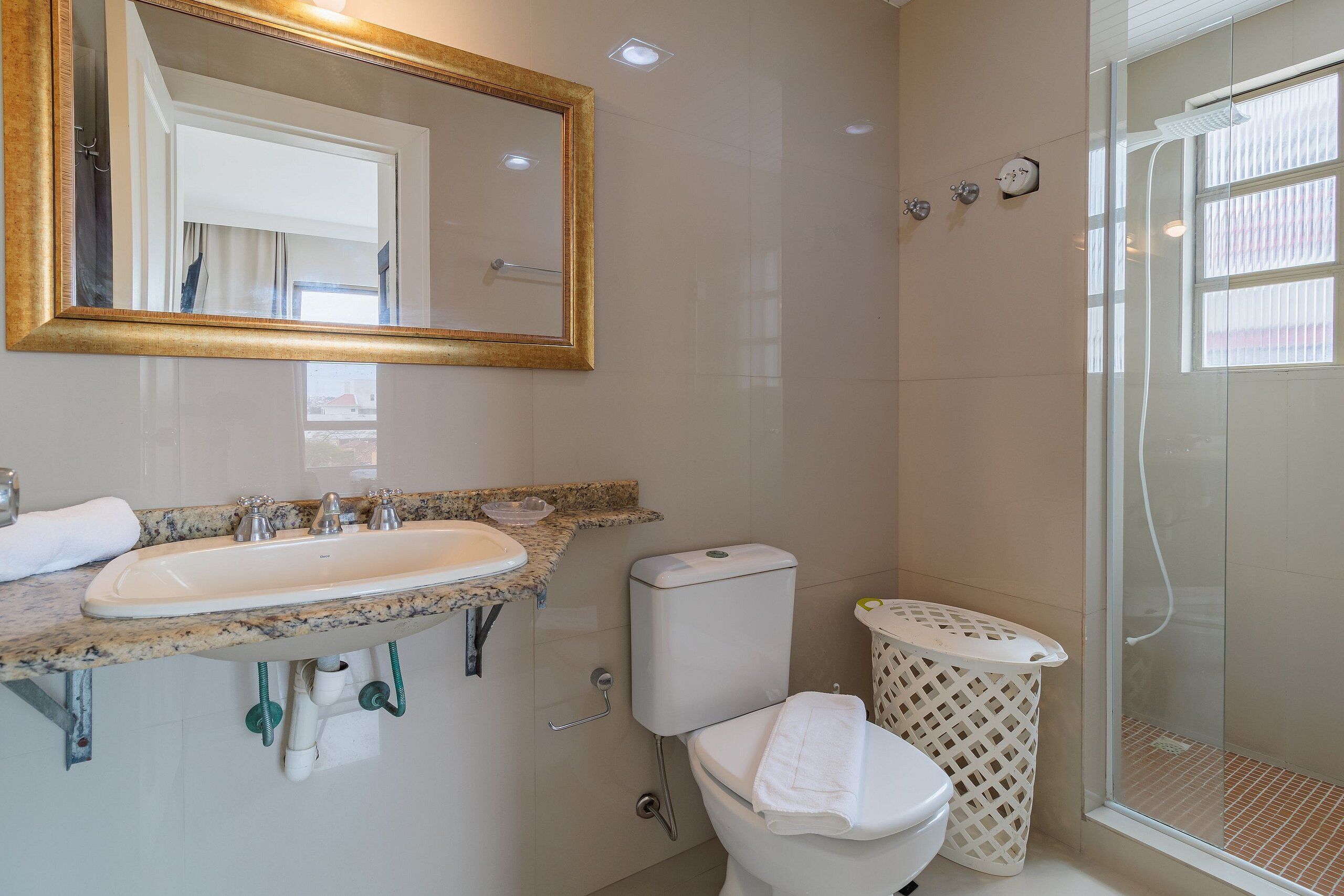 A bathroom with a sink, toilet, and shower.