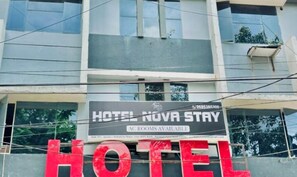 A sign for Hotel Nova Stay advertising AC rooms.