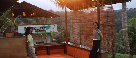 A resort with a covered outdoor area, a sign for 'Mercure Resorts Waycana', and a view of the surrounding landscape.