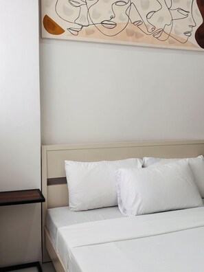 Tabla de planchar con plancha y ropa de cama