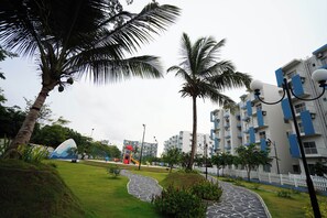A residential building with balconies, a playground, and a paved pathway. - Negombo Airport Villa with Pool, Parks and Breakfast (Negombo)