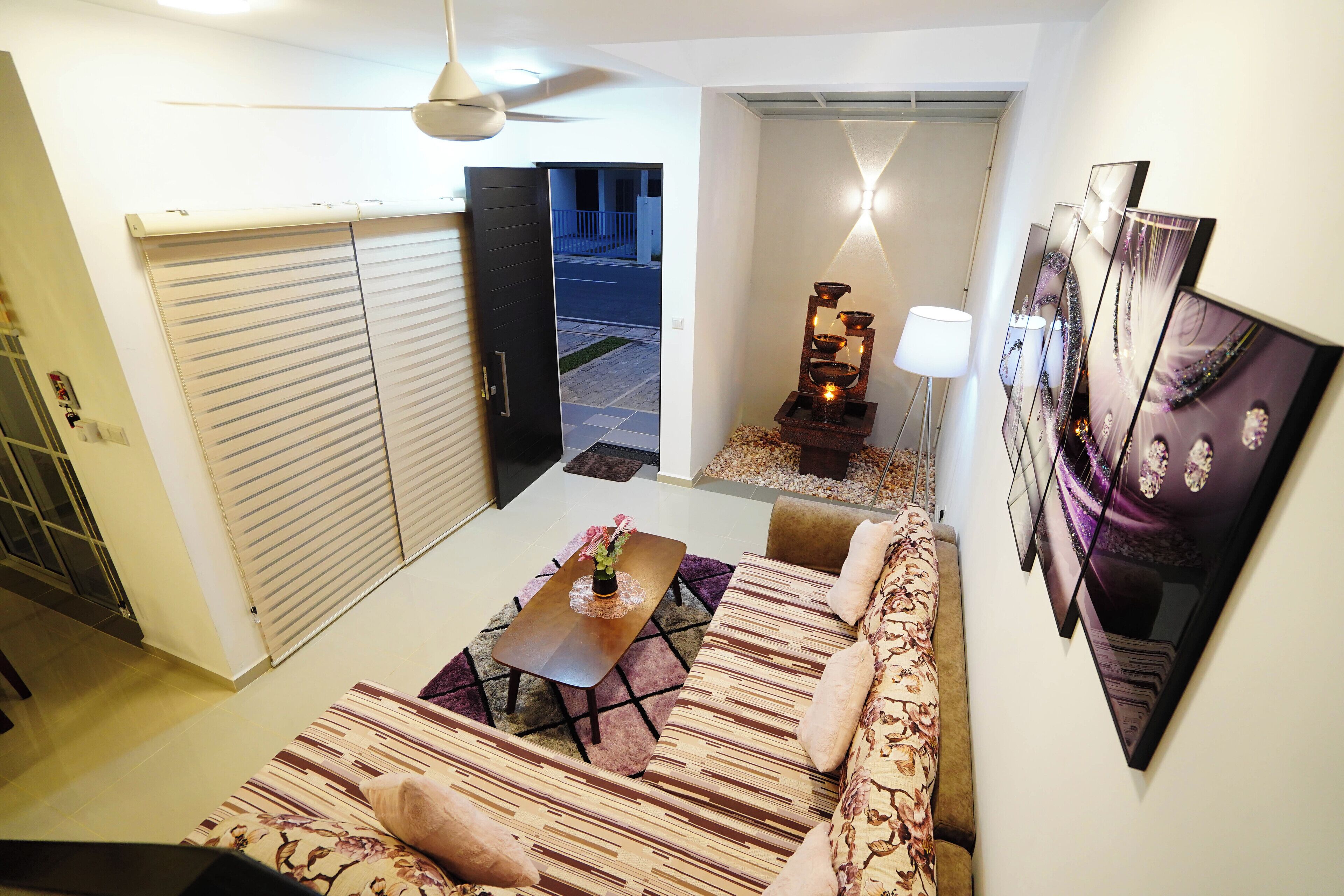 A modern living room with a sofa, a coffee table, and a decorative lamp.