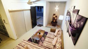 A modern living room with a sofa, a coffee table, and a decorative lamp.
