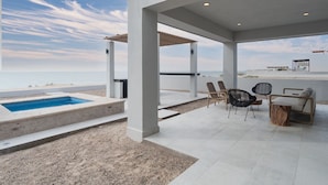 A covered outdoor area with a pool, seating, and a view of the beach. - 4 BR Luxurious Oceanfront Casa Estrella in Islas del Mar (Puerto Peñasco)