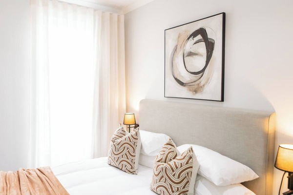 Experience the elegance of restful nights with our luxurious queen bed, enveloped in premium linens for the ultimate in comfort and style.