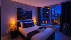 A hotel room with a large bed, two bedside lamps, a cityscape view, and a window overlooking a building.