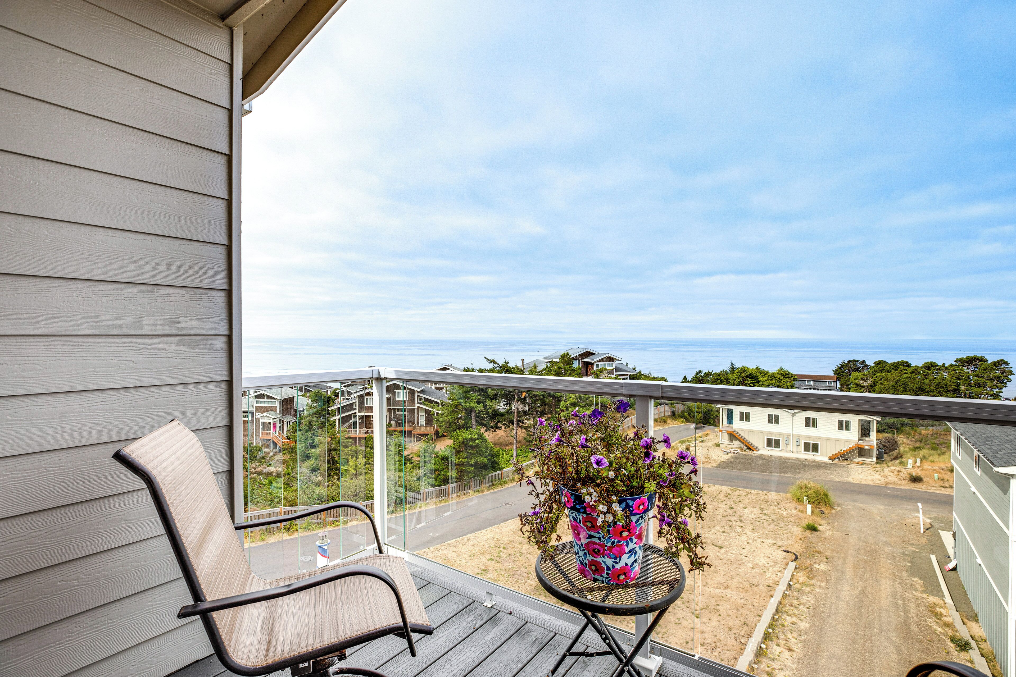 Ein Balkon mit einem Stuhl, einem kleinen Tisch und einem Blumentopf.
