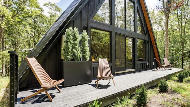 A modern wooden deck with two lounge chairs and a large window overlooking a forest. - 1 Mi to Resort Beach: Alpine Lake A-Frame! (Terra Alta)