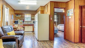 A compact motel room with a kitchenette, a dining area, and a separate bedroom. - Shared Dock & Yard: Greers Ferry Lake Home! (Greers Ferry)