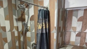 A bathroom with a shower, toilet, and sink. - H'Eden Treasures Studio 2 (Belle Plaine)