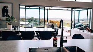 A modern kitchen with a large window overlooking a scenic landscape.