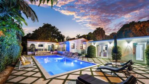 A swimming pool with lounge chairs and a patio area with a tiled floor. - Lux•PrimeLocation•HtdResortPool•OutdrDining (West Palm Beach)