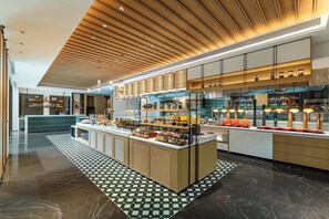 Een moderne keuken met een centraal eiland, houten plafond en betegelde vloer.