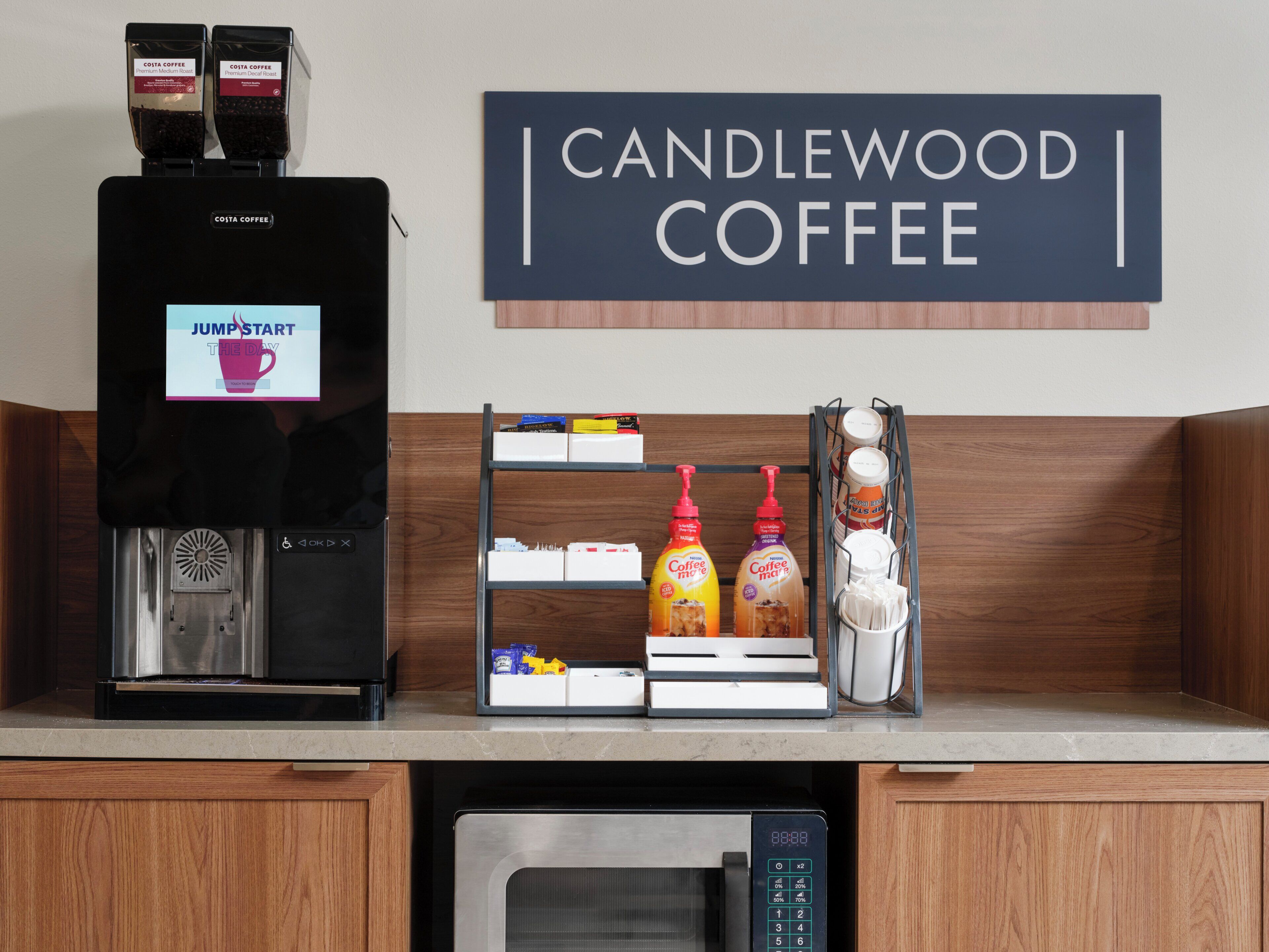 A coffee machine, a coffee station with various coffee products, and a microwave.
