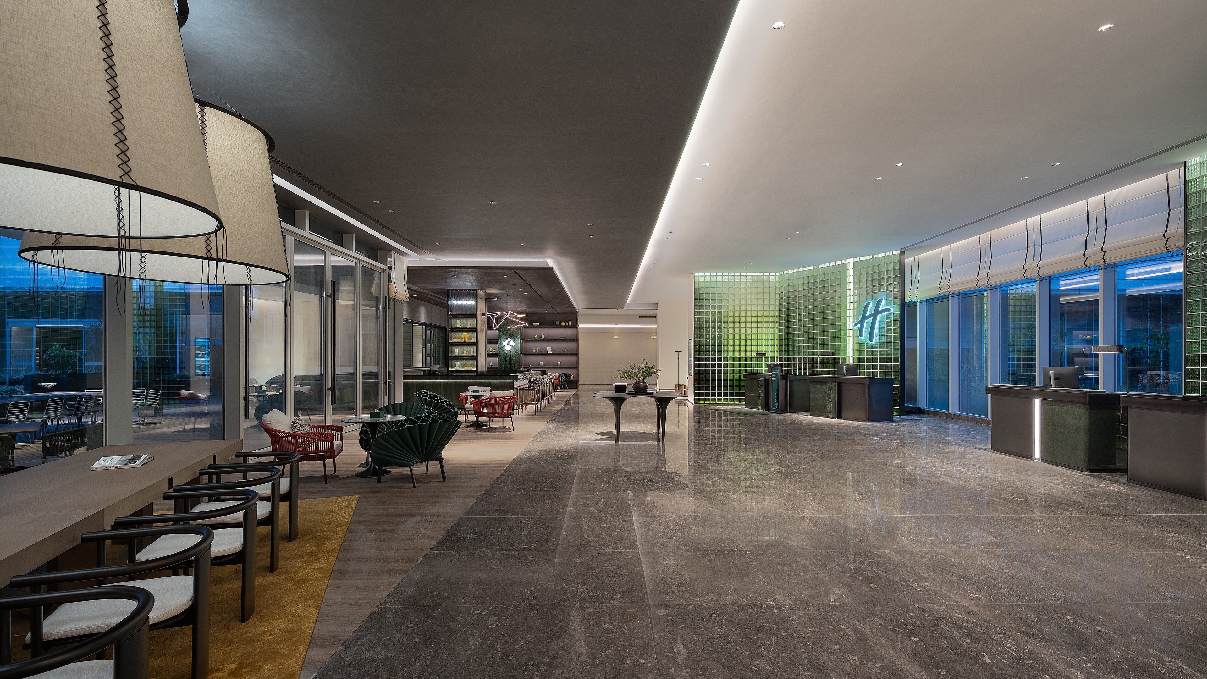 A modern hotel lobby with a long reception desk, seating area with chairs and tables, and a bar.