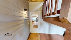 A wooden interior hallway with a white door leading to a room. - Reserve 13C • Sugar Mtn. Getaway with Big Views (Sugar Mountain)