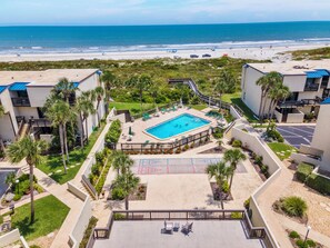 A resort with a swimming pool, beach view, and multiple guest rooms. - Robin's Nest at Island House G234 (St. Augustine)