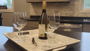 A kitchen counter with a wine bottle and two glasses. - Serene 2-bedroom house in Indiana. (Indiana)