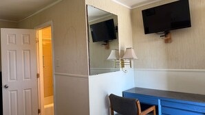 A hotel room with a desk, chair, television, and a mirror. - Tourest Motel (Peru)
