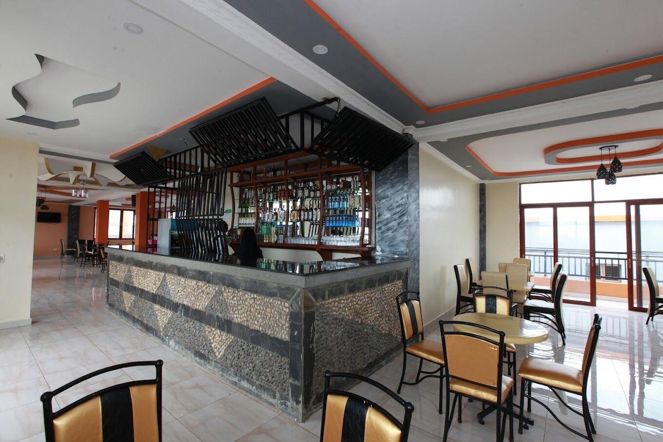 A bar area with a stone counter and seating for guests.