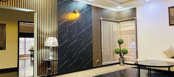 “Spacious King Rooms Prime DHA Location Perfect for Business & Family Stays