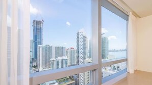 A high-rise apartment with large windows offering a city view.