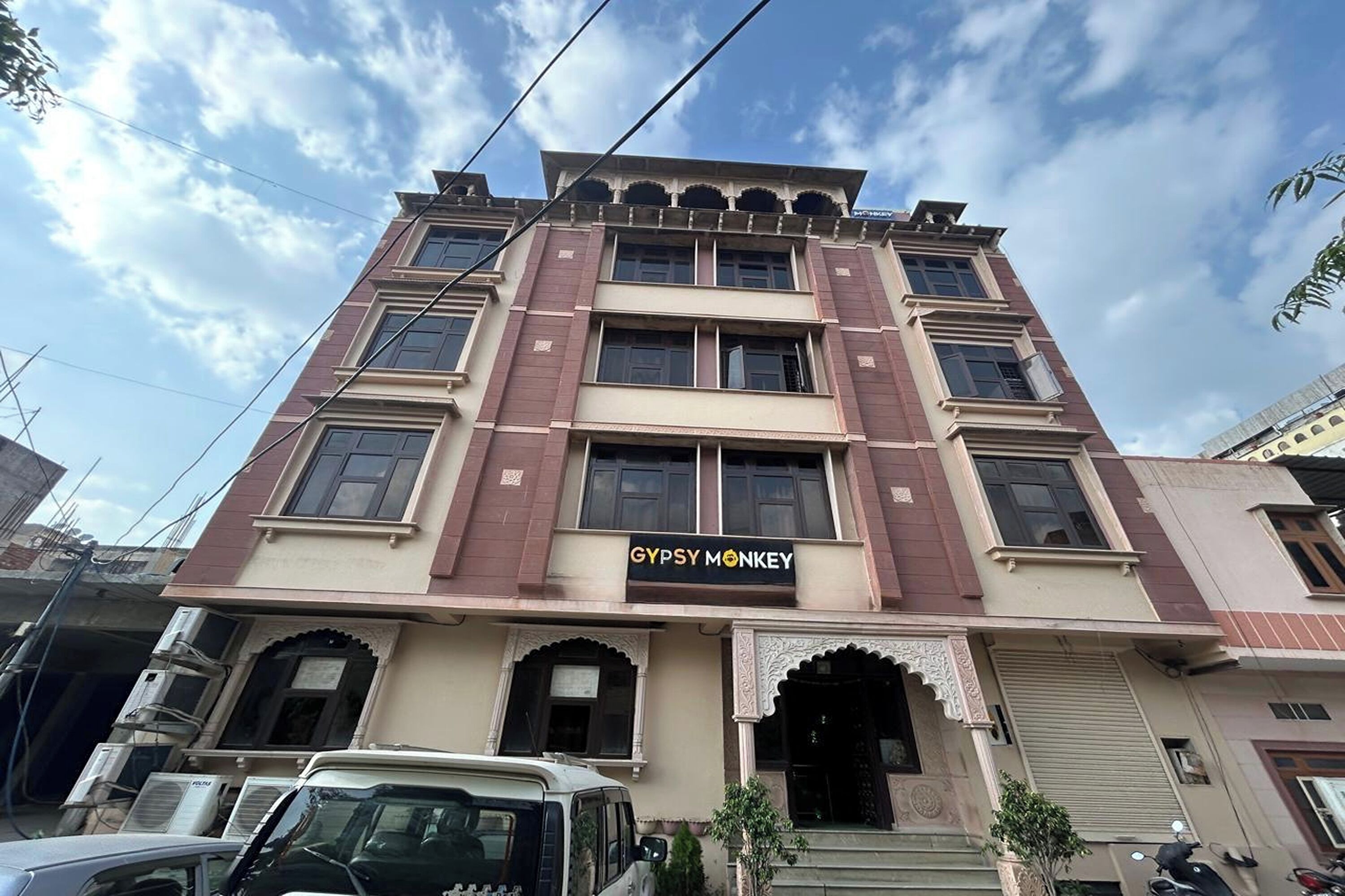A multi-story building with a sign for 'GYPSY MONKEY' on the ground floor.