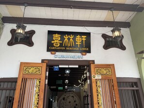 The entrance to Carnarvon Heritage Lodge with traditional decor and a sign indicating the name and address. - Carnarvon Heritage Lodge (George Town)
