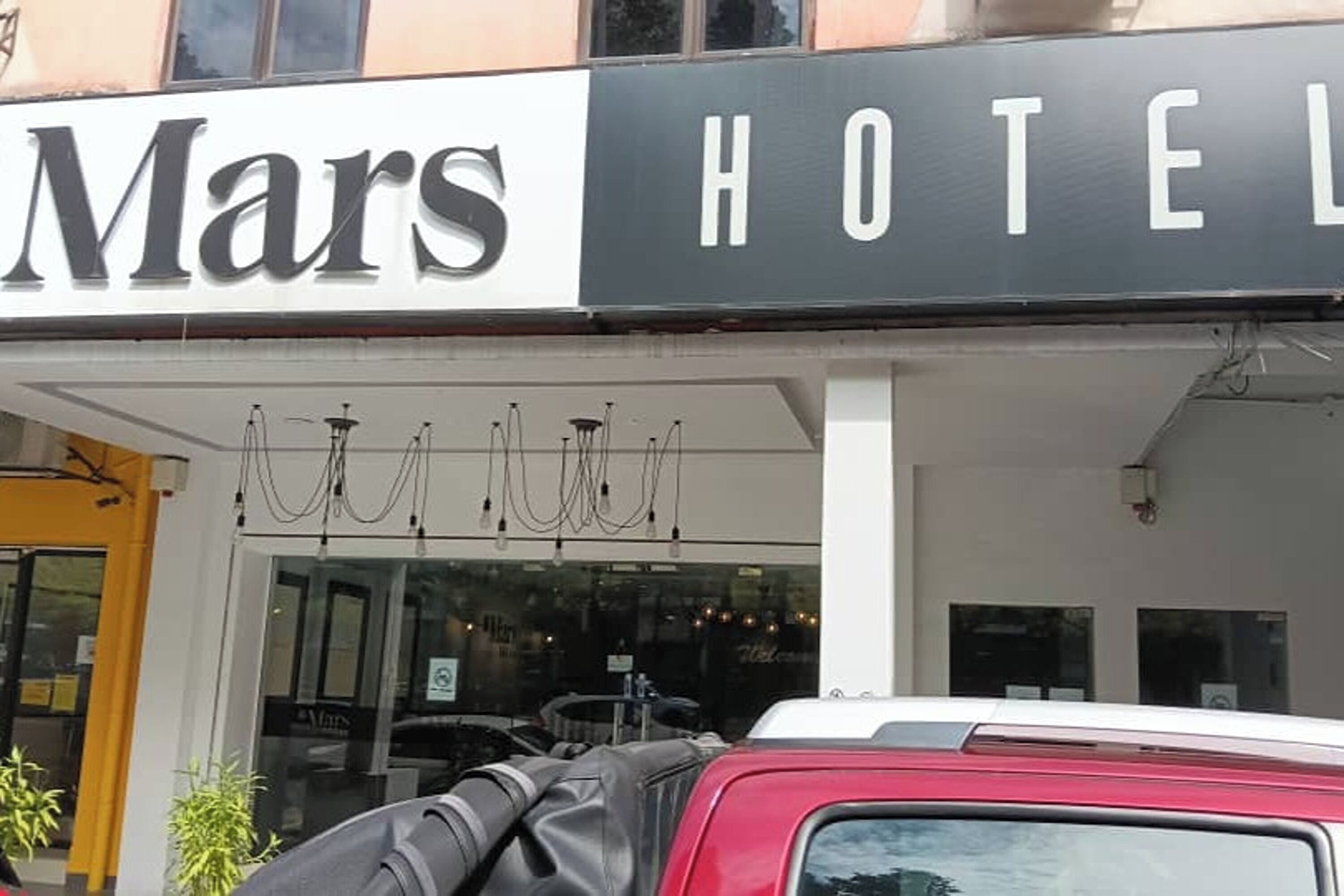A hotel named 'Mars' with a sign above the entrance.
