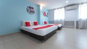 A hotel room with two beds, a window with curtains, an air conditioning unit, and a wall with a circular decoration.