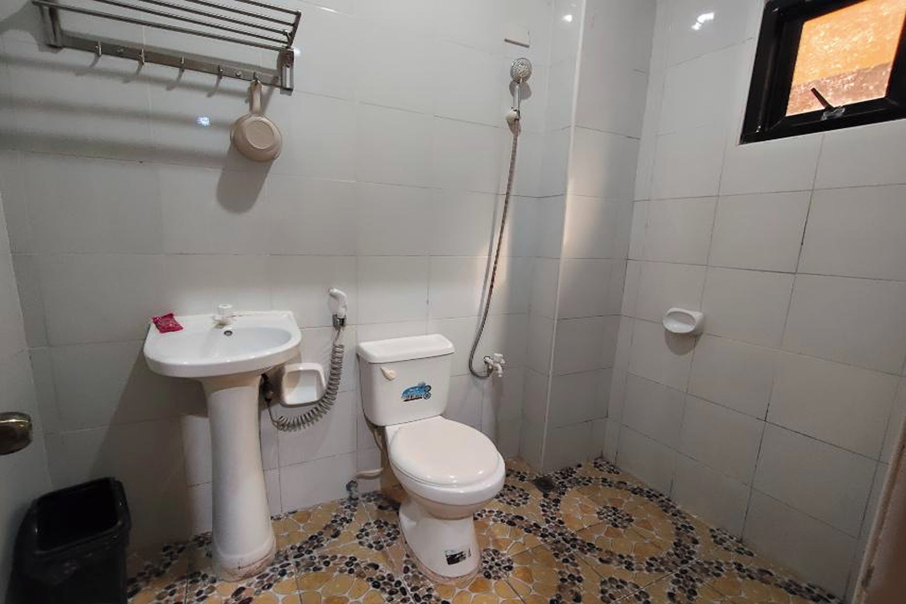 A bathroom with a toilet, sink, and shower.