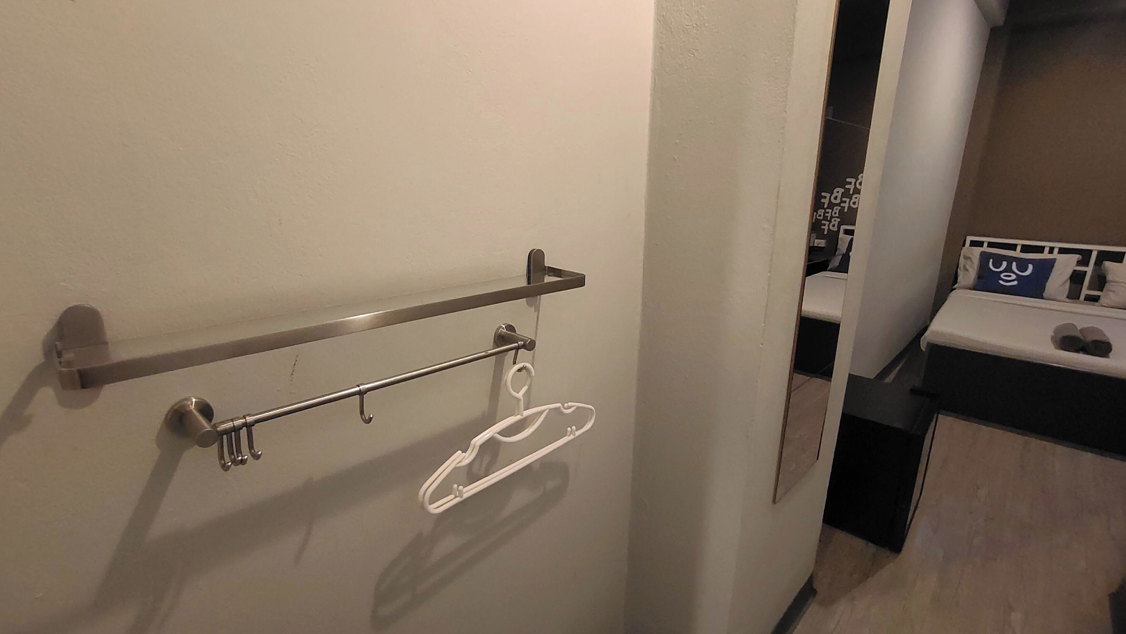 A bathroom with a towel rack and a towel hanging on it.
