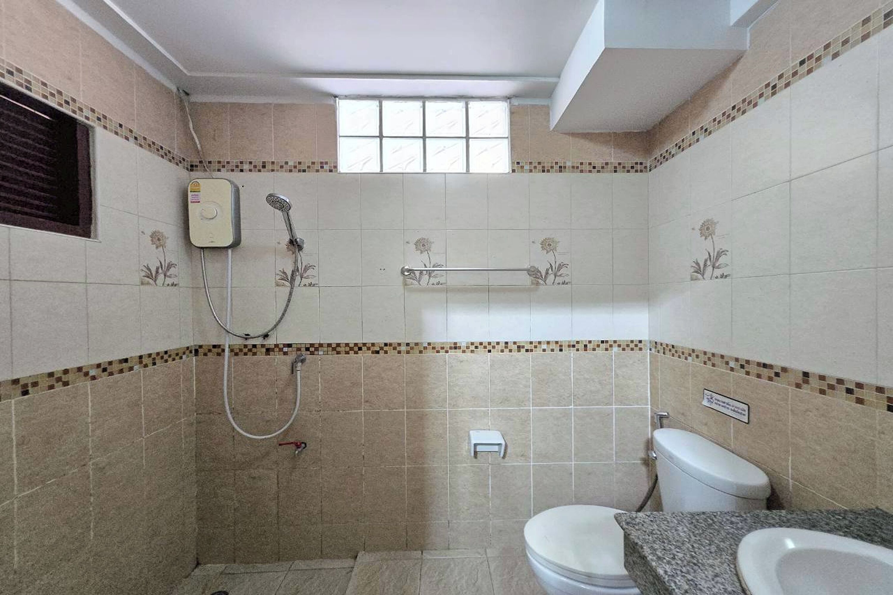 A bathroom with a shower, toilet, and sink.