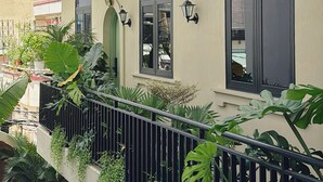A building with multiple balconies, some with plants, and a flat roof. - G'Villa Thao Dien (Ho Chi Minh City)