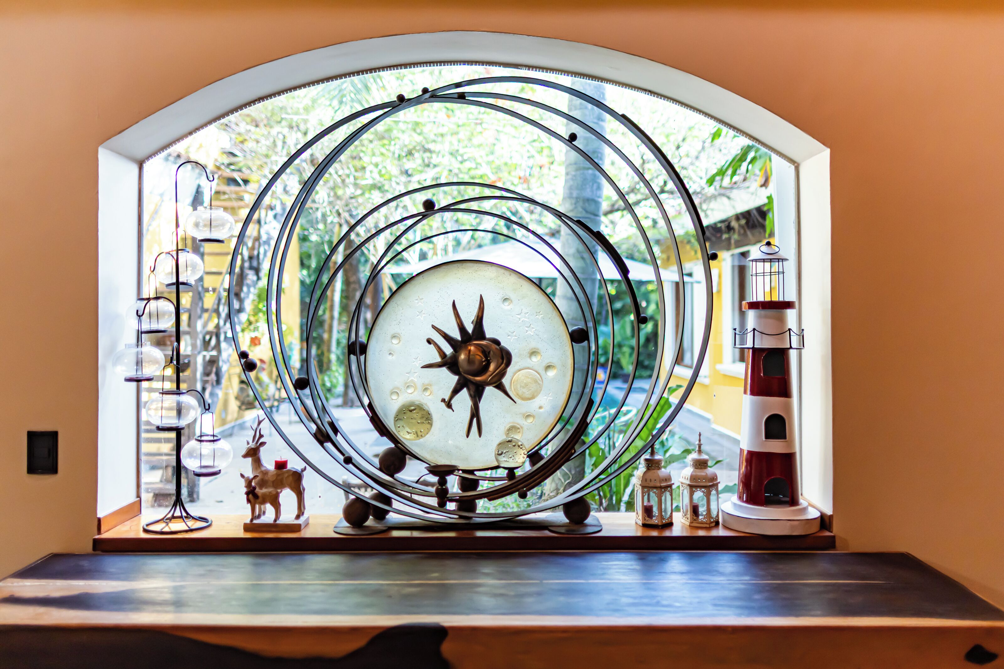 A decorative clock with concentric circles and a lighthouse model.