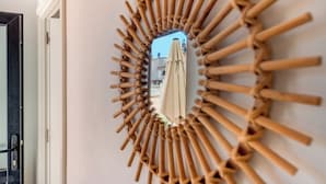 A wall-mounted mirror with a bamboo frame. - 1 bedroom apartment w/pool - Vilamoura Marina Center (Quarteira)