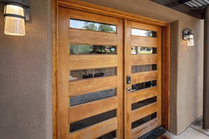 A wooden double door with glass panels and a keypad lock. - Peaceful and Convenient, Inviting Patio (Santa Fe)