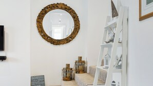 A staircase with a mirror, a sign with beach house rules, and a white shelf with decorative items. - All that Salcombe has to offer from your perfect family base. (Salcombe)